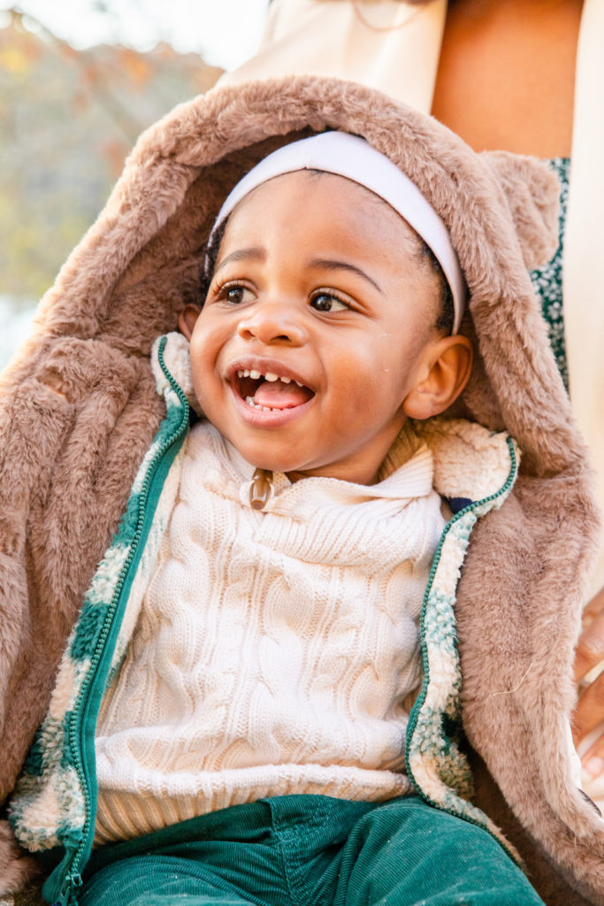 toddler boy portrait with hoodie laughing in Brookhaven GA during fall family pictures