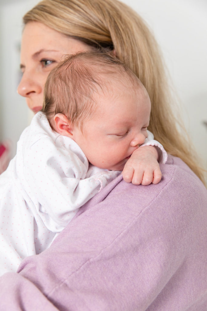 newborn portrait sleeping on mom shoulder during family session in Atlanta