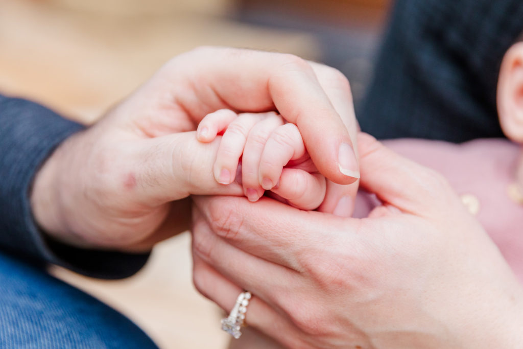 details baby and parents hands by lifestyle family photographer Laure Photography