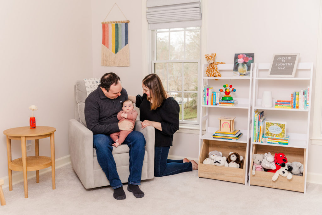 parents and 3 month old baby girl sitting in the nursery in Dunwoody GA