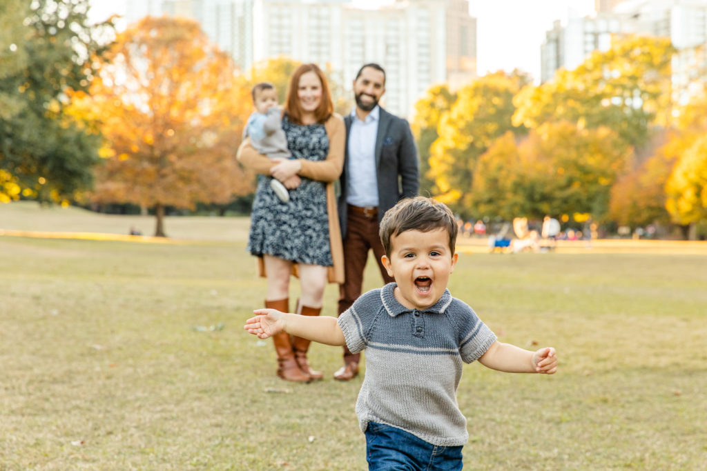 lifestyle toddler running toward the camera during family photo session in Atlanta park with laure photography