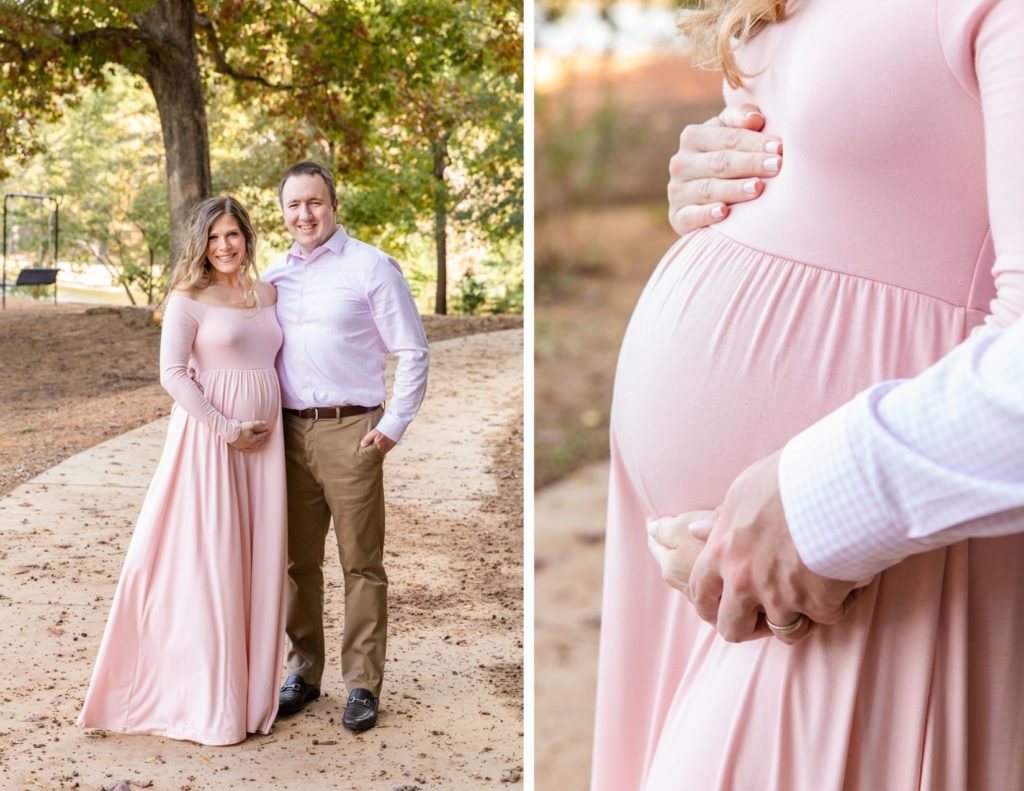 pregnant couple in long light pink dress and coordinated shirt and beige pant standing in an Atlanta park with Laure photography