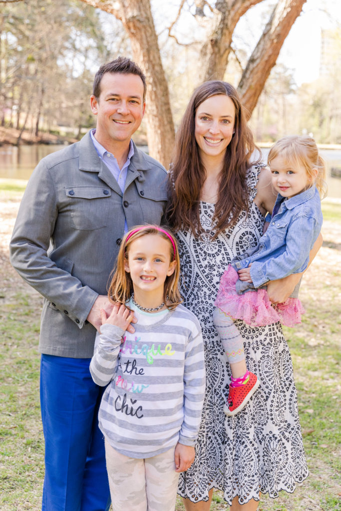 family with two daughters standing in Atlanta Duck Pond park during photo session with Laure Photography Atlanta