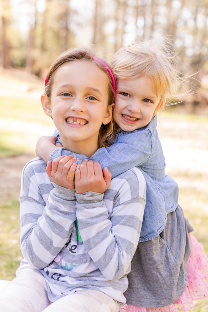 sibling hugging during an outdoor family photoshoot by Laure Photography Atlanta