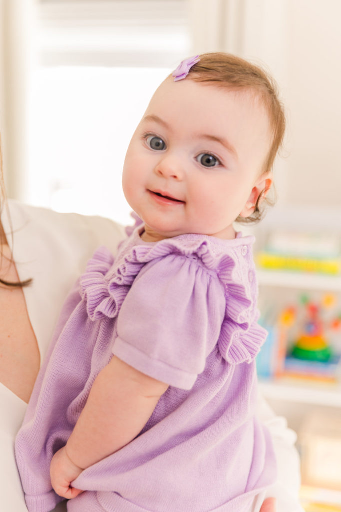 6 month old baby milestone photo session in coordinate purple dress and bow Atlanta GA family photographer