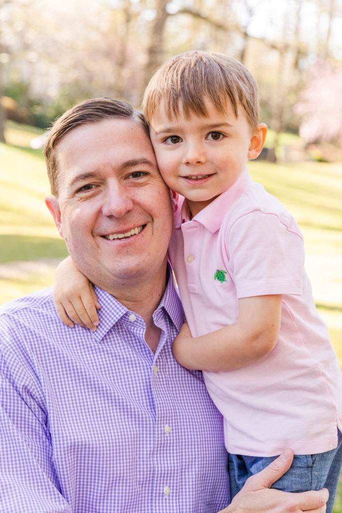 dad in shirt and son toddler son in pink polo hugging with Laure Photography Atlanta