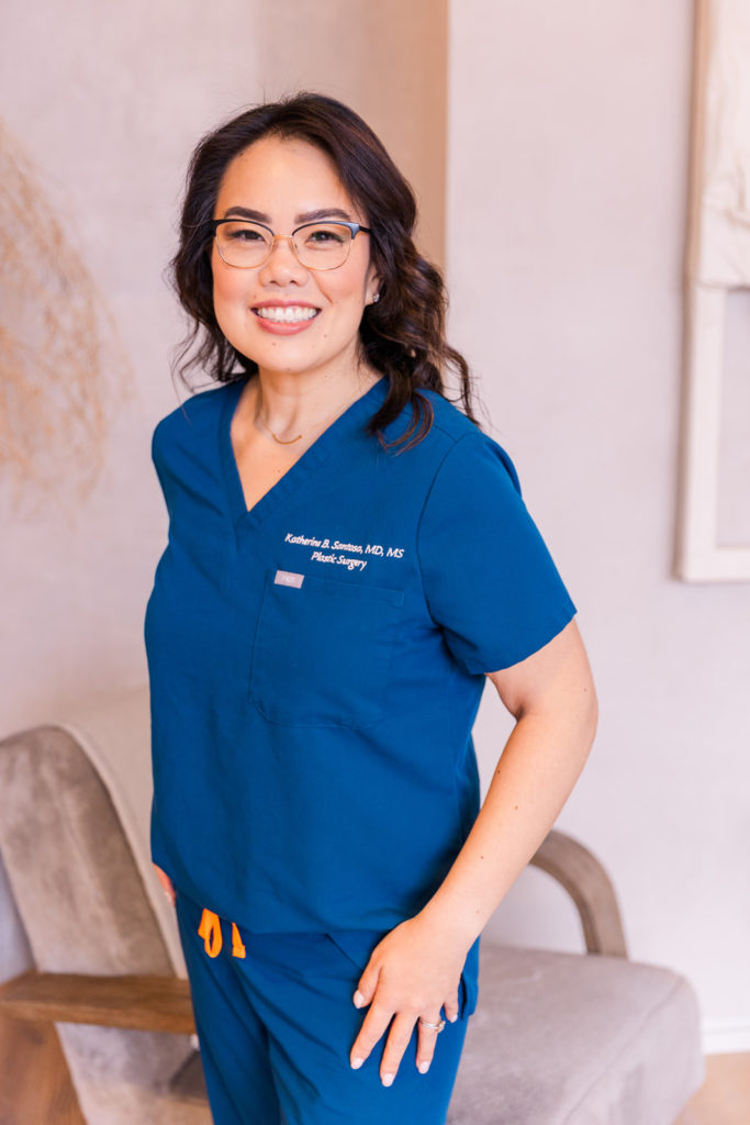 surgeon doctor standing in blue scrubs during brand photo session Atlanta with Laure Photography