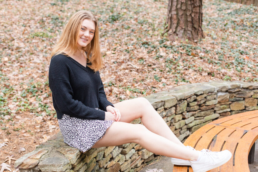 Girl teenager Atlanta high school graduate senior photo sitting on a wall session by Laure Photography