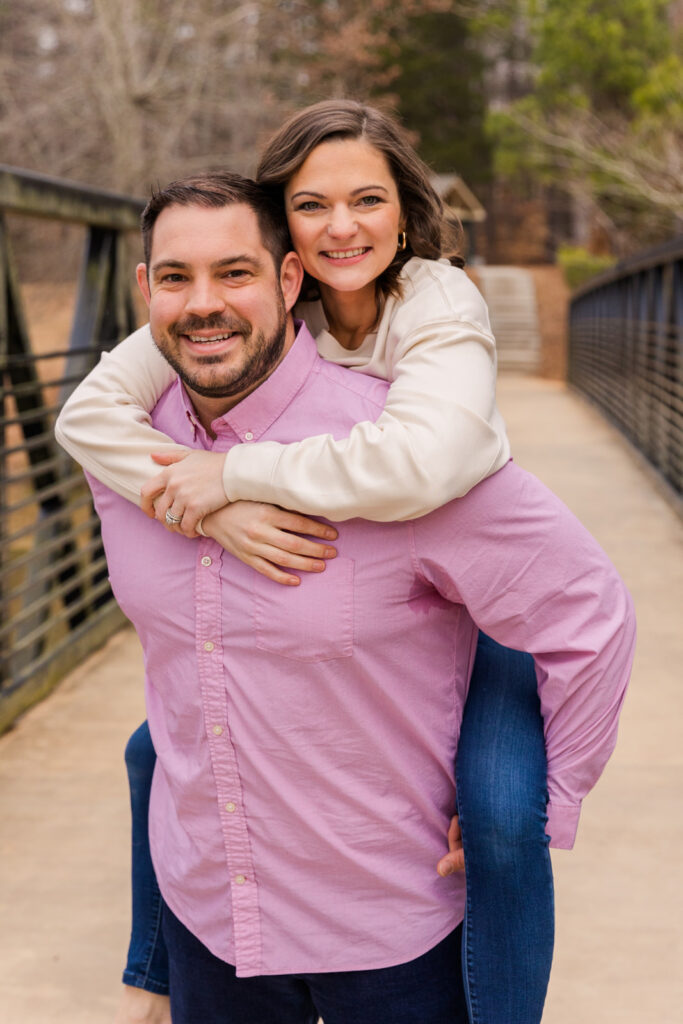 Couple portrait with woman doing a piggyback rid on her husband by Atlanta family photographer Laure Photography
