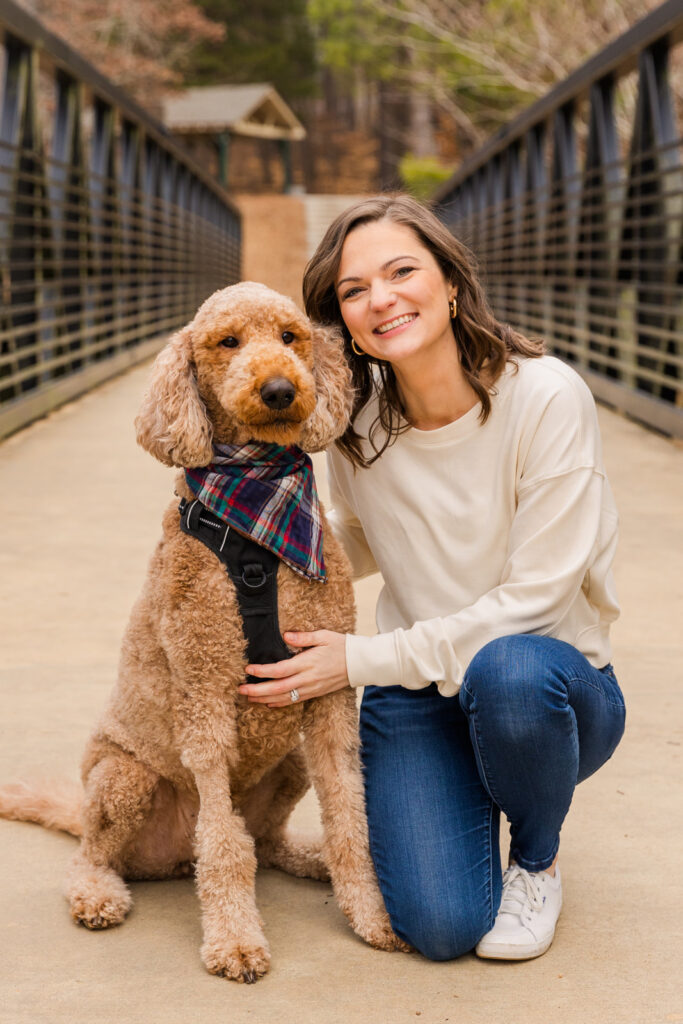 Woman with her dog in a park bridge by Atlanta family photographer Laure Photography