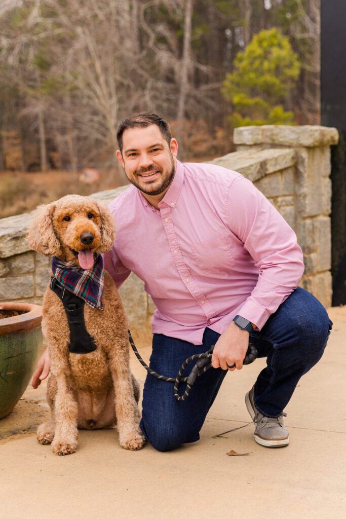 portraits of a dog golden-doodle and his owner in a bridge during photo session by Atlanta family photographer Laure Photography