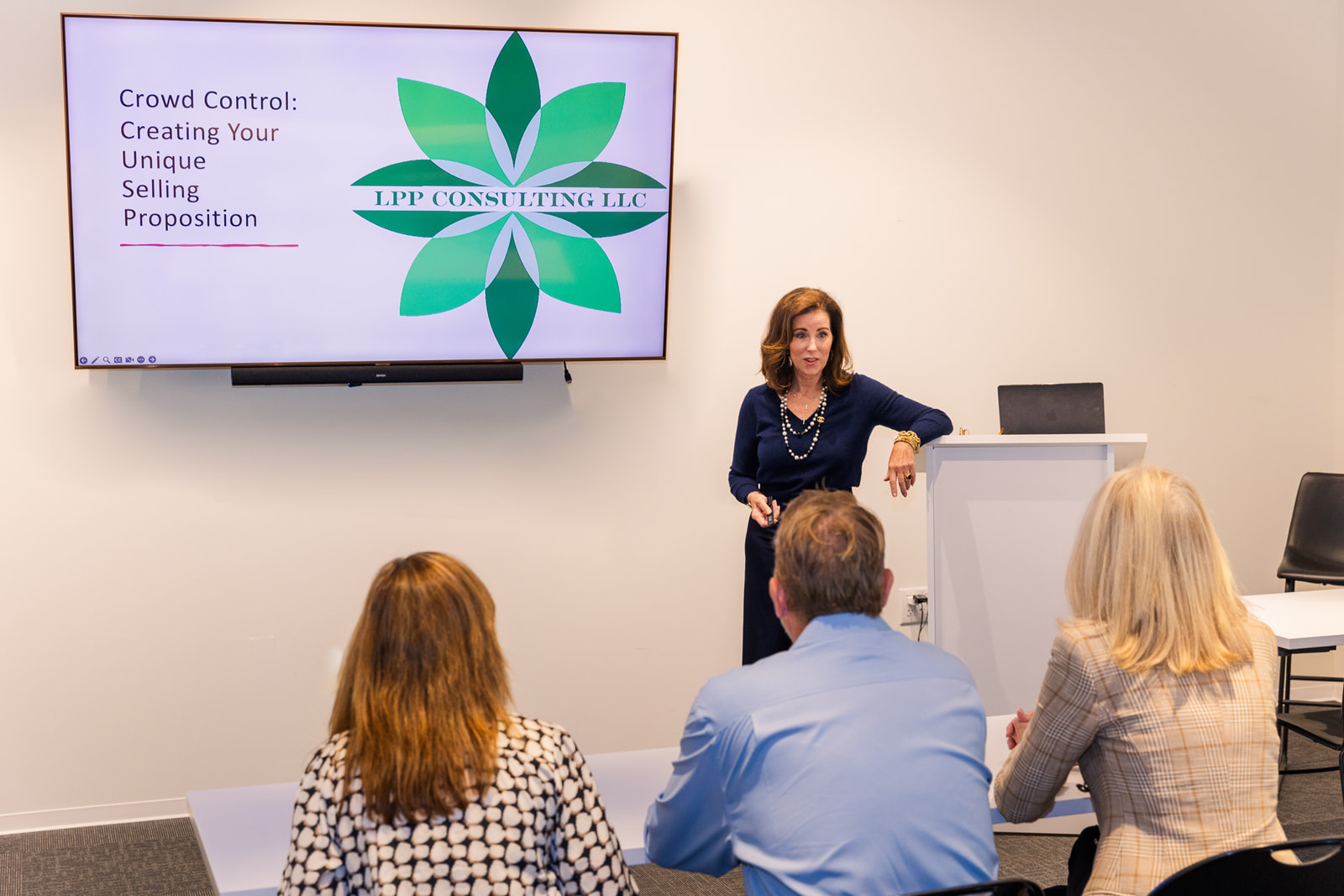 woman wearing navy blue dress talking during a seminar brand photo shoot Atlanta with Laure Photography