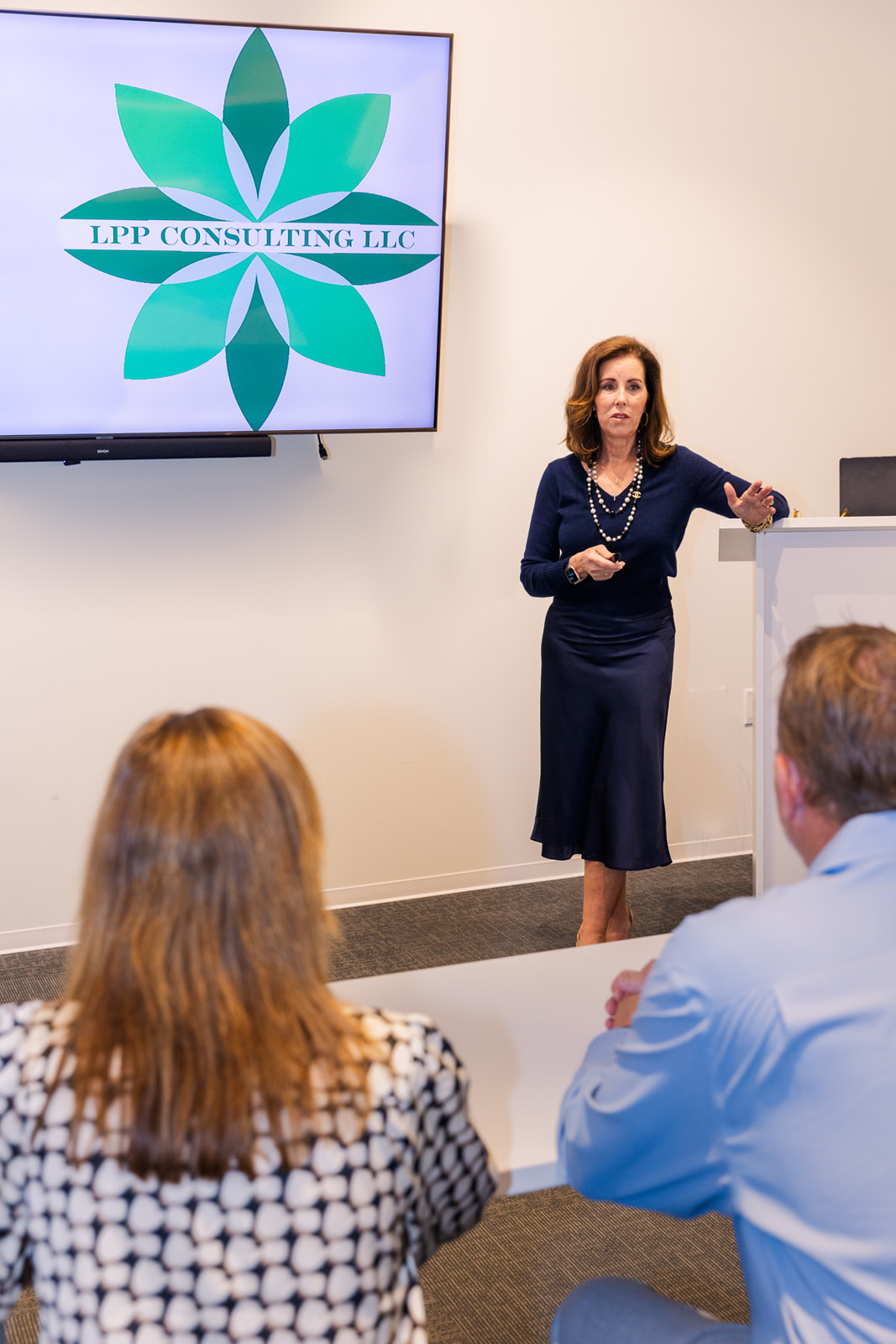 woman presenting and talking to an audience during a seminar brand photo shoot Atlanta with Laure Photography