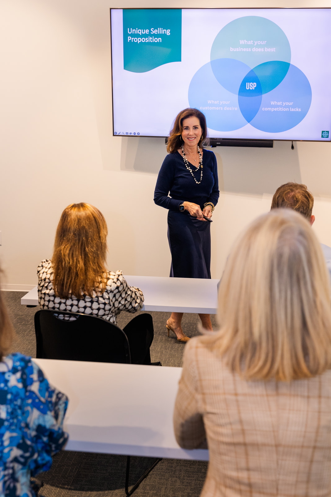 women explaining consulting strategy during a seminar in a meeting room brand photo shoot Atlanta with Laure Photography