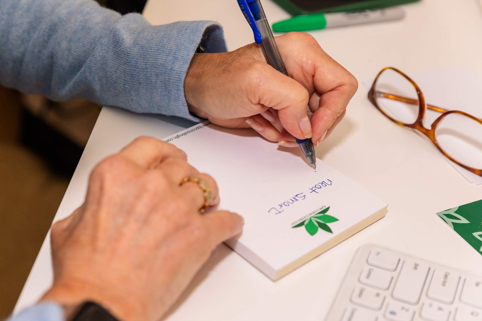 detail of woman writing a note on an in brand stationary item during brand photo shoot Atlanta with Laure Photography