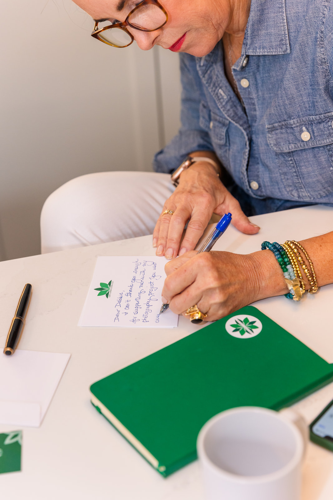 women writing a thank you note on her business card brand photo shoot Atlanta with Laure Photography