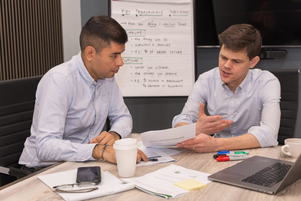 Consultant and team discussing documents during business meeting in conference room Atlanta