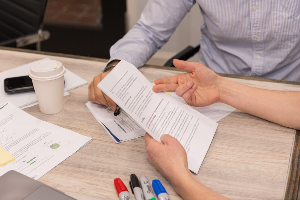 Close-up of hand pointing at document during business meeting in Atlanta