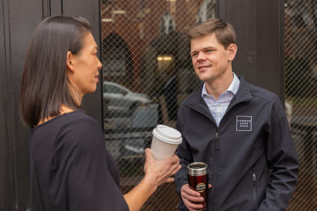 Consultant in conversation with client in front of coffee shop in Atlanta during brand session