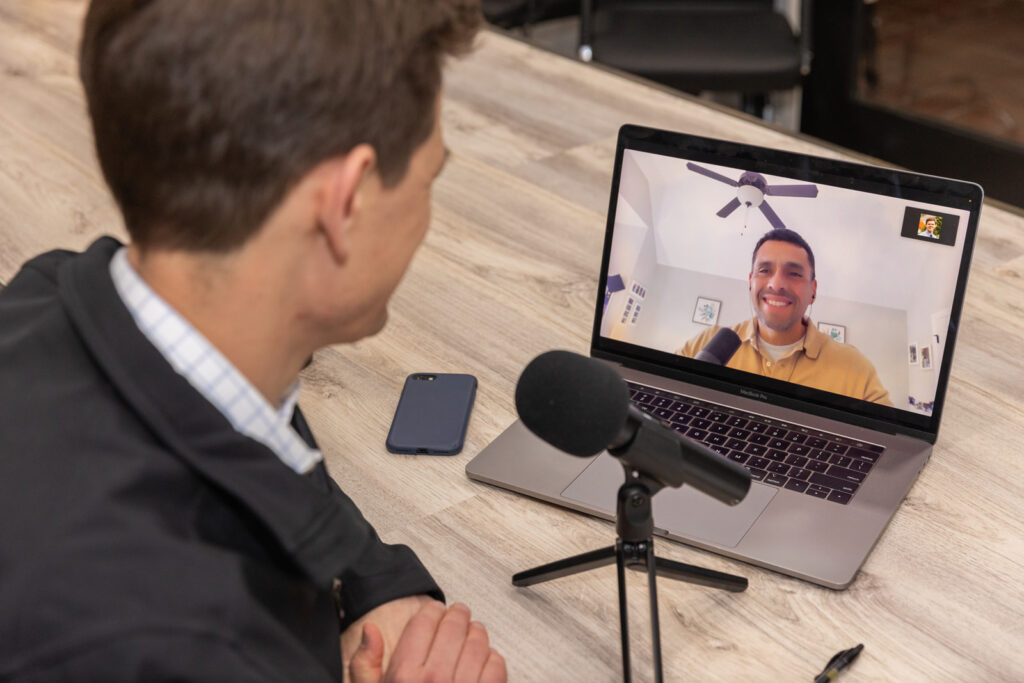 Consultant recording a podcast and attending a Zoom meeting during brand photoshoot in Atlanta conference room, by Laure Photography