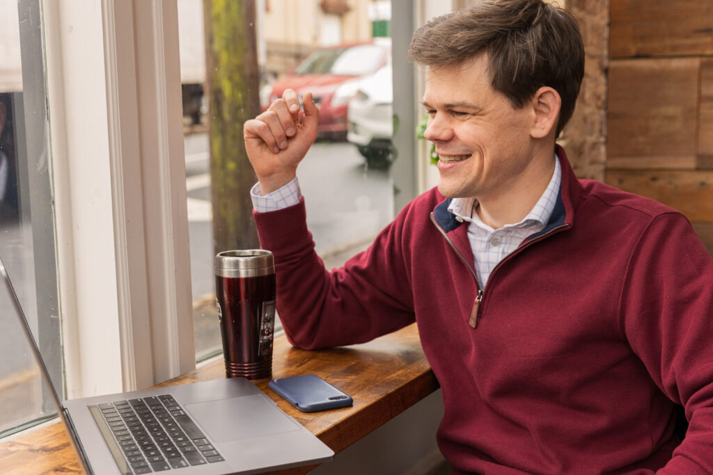 Consultant having a Zoom meeting in a coffee shop during personal brand photoshoot in Atlanta