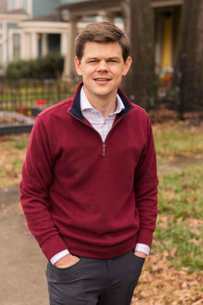 Professional headshot of consultant standing hands in pockets on Atlanta street, by Laure Photography