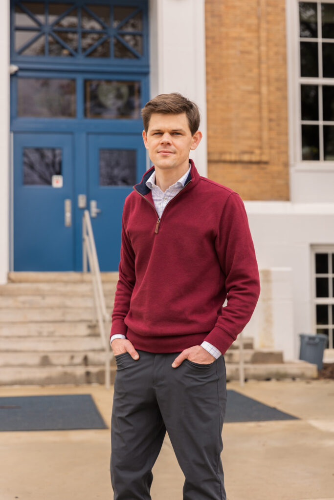 Business portrait of a consultant standing hands in pockets in front of a public building in Atlanta