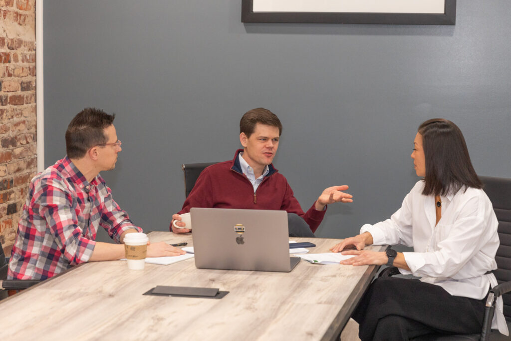 Team collaborating and talking during corporate business meeting in Atlanta, photographed by Laure Photography