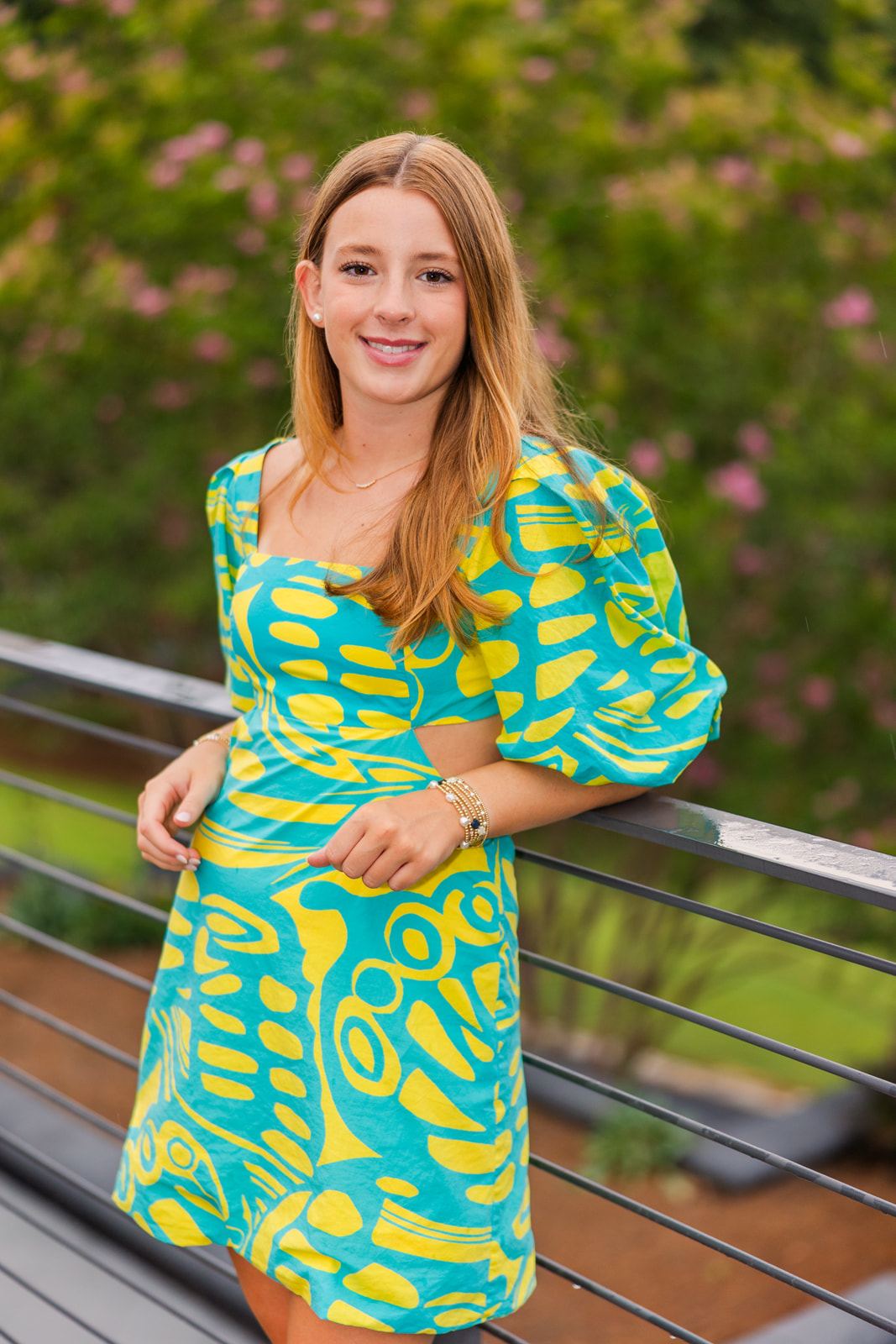 teenage girl wearing a blue and yellow dress in Buckhead Atlanta GA park during portrait photo session