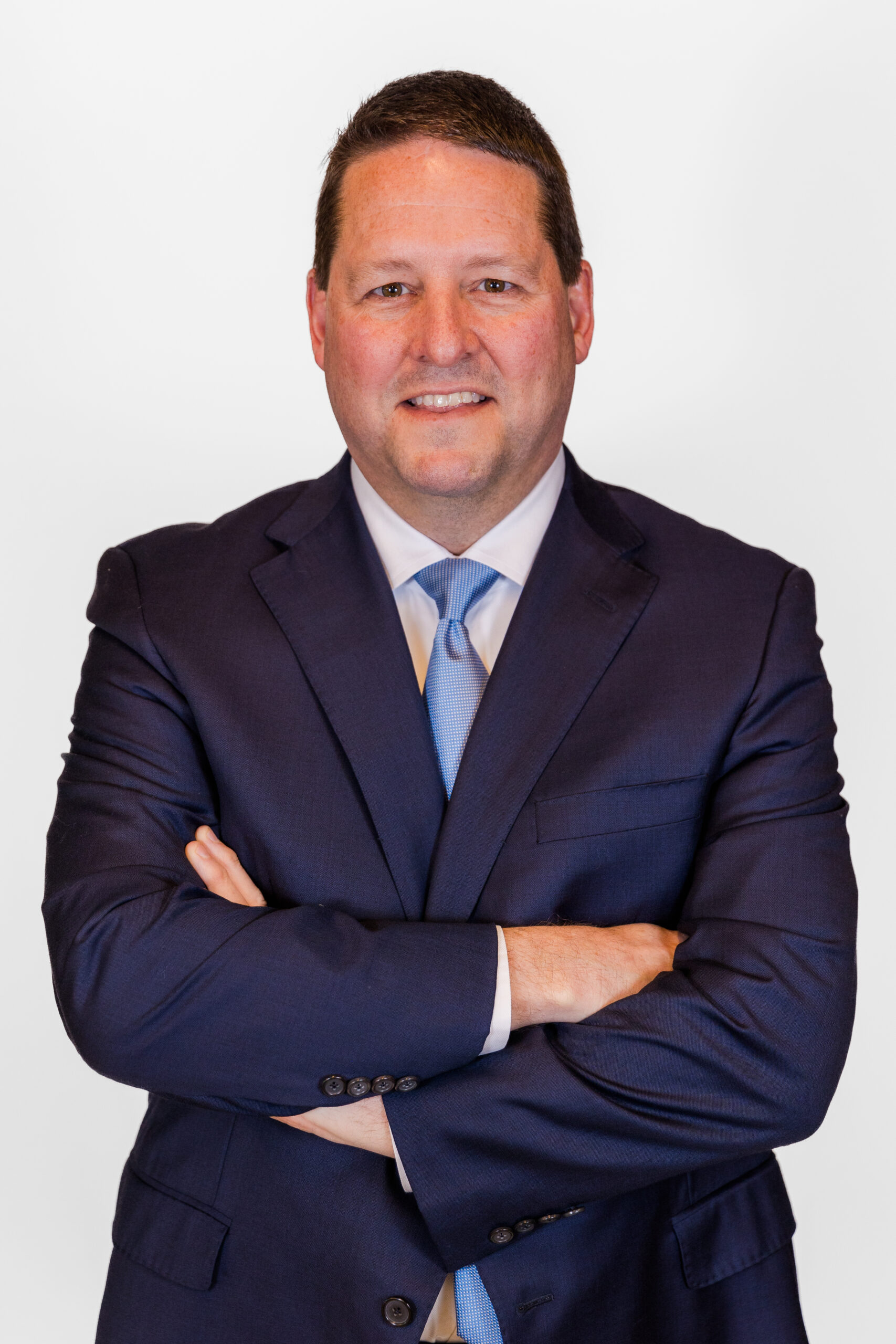 Alan Kennedy facing the camera arms crossed during professional headshots mini session at his Atlanta midtown office