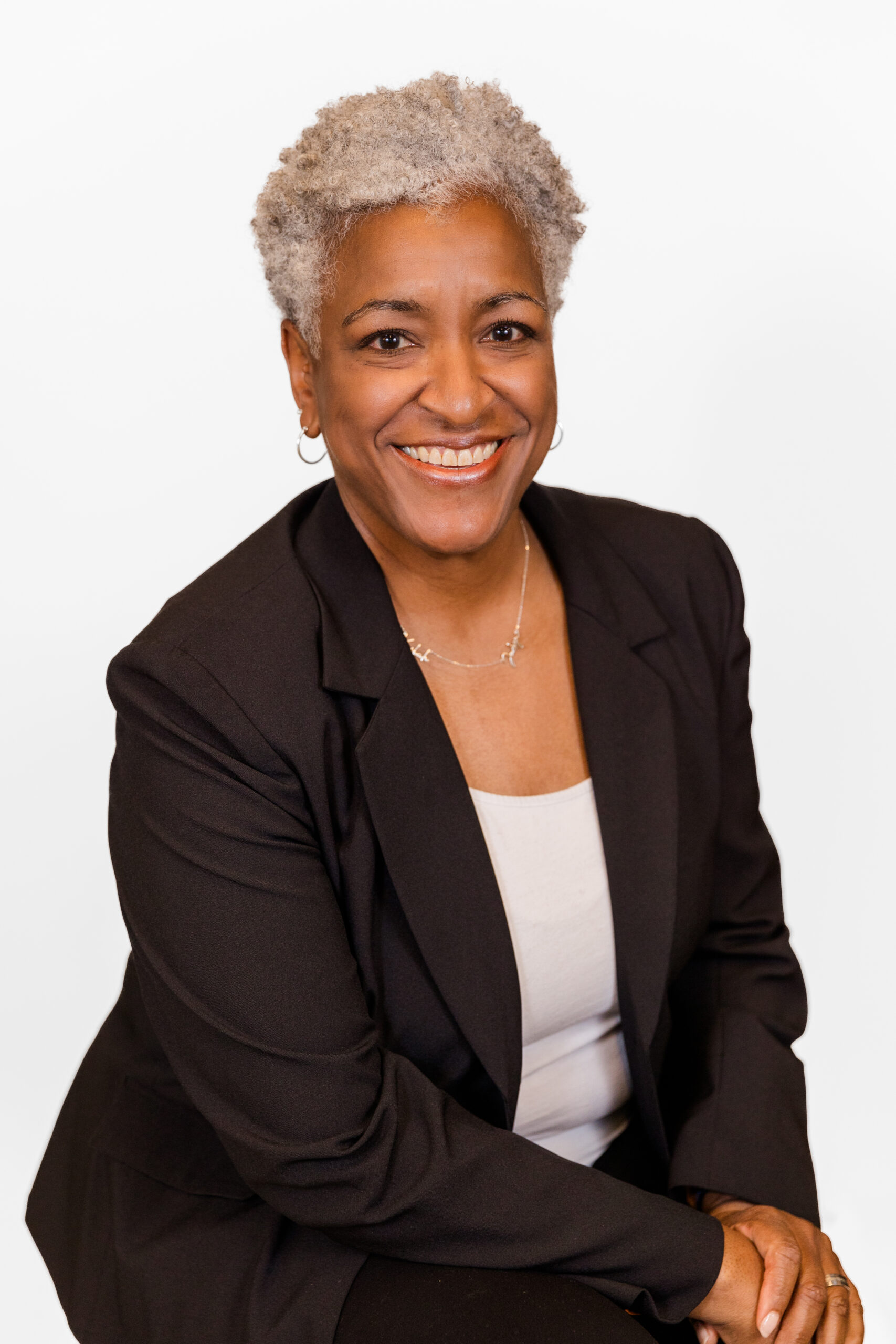 Dawn Sparks wearing white top and black jacket during professional headshots in the Atlanta midtown office