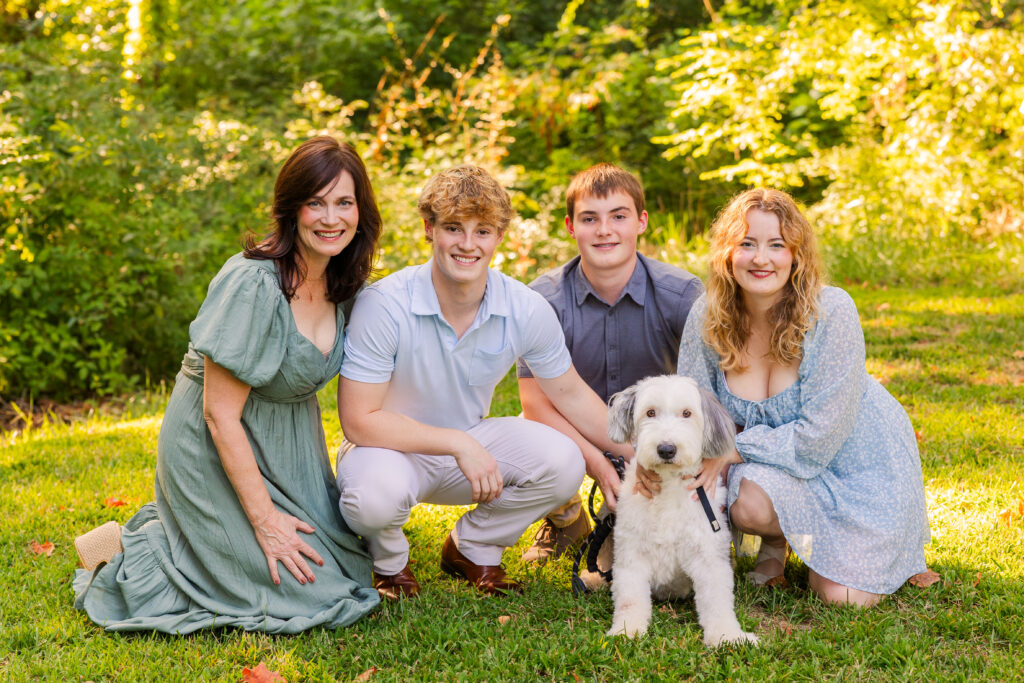 outdoor Atlanta family photo session with mom and 3 teenager kids and dog wearing coordinated outfits