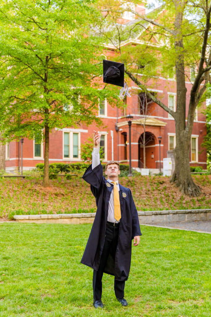 Jason throwing his graduation cap in the air on Georgia Tech campus.