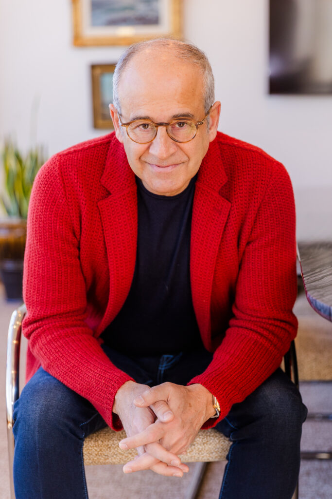 Ahmet Bozer sitting on a chair, leaning on his knees, hands together, facing the camera during his Atlanta Buckhead personal branding session