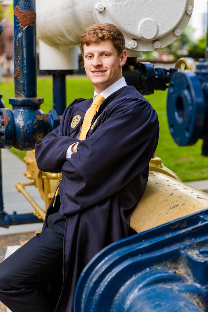 Jason leaning against an engineering history machine on Georgia Tech campus.