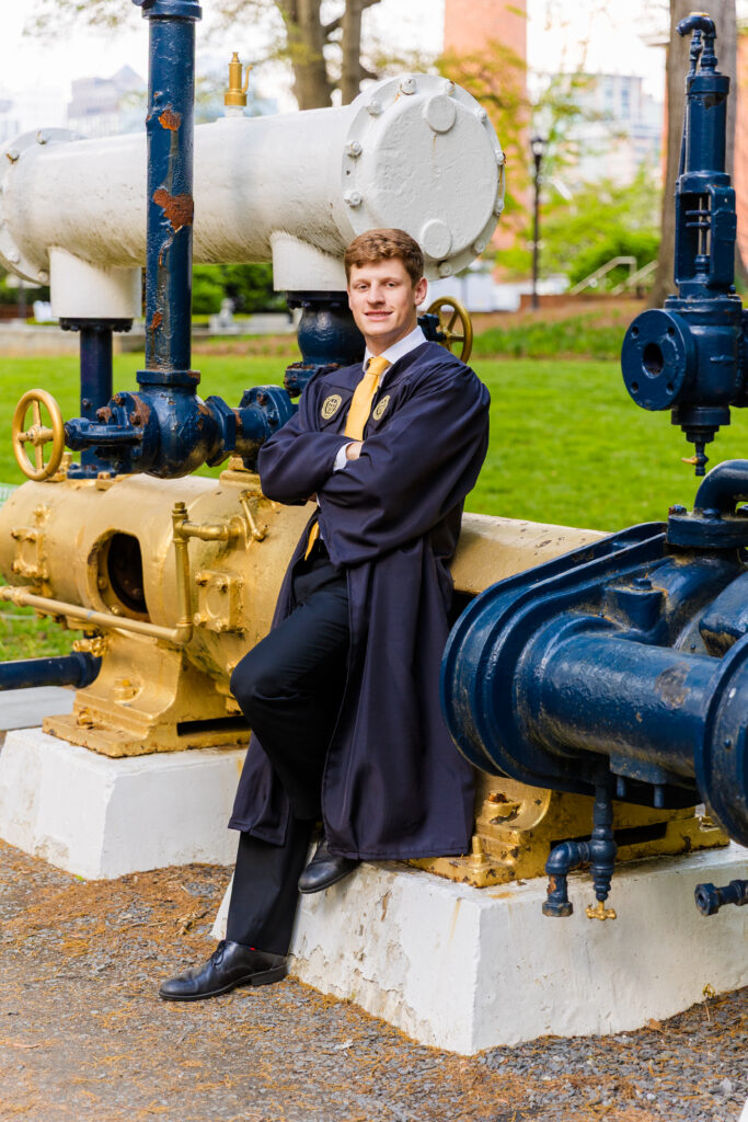 Jason standing in front of a historical engineering machine outside at Georgia Tech