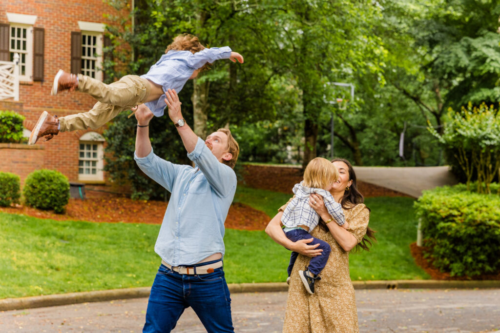 Parents catching their children in mid-run for a joyful action shot.