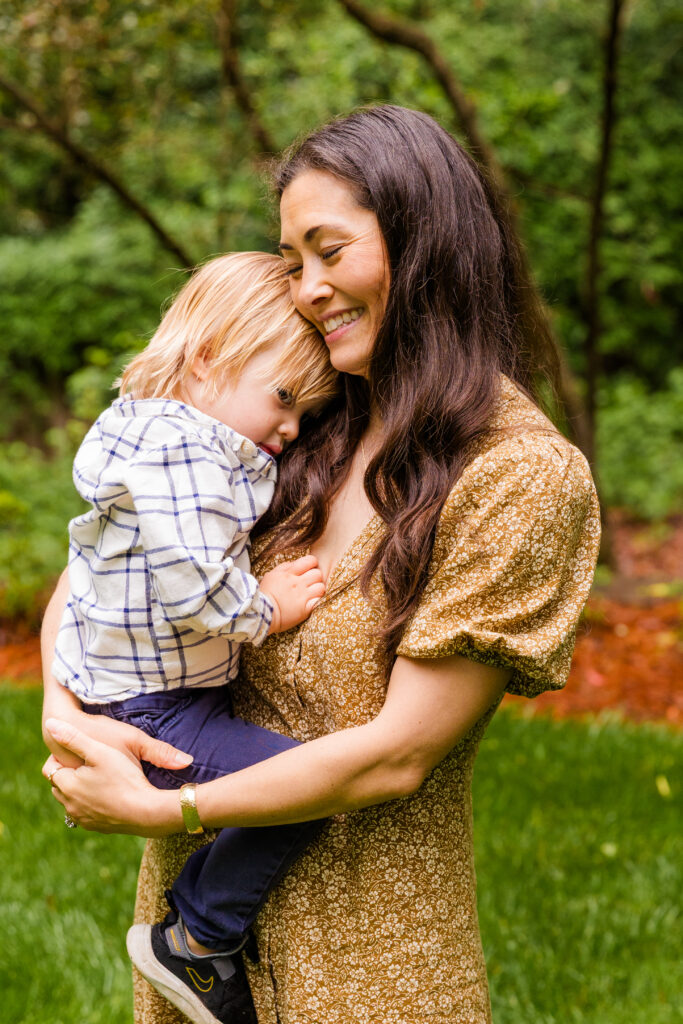 Sweet portrait of mom embracing and smiling at her young son.