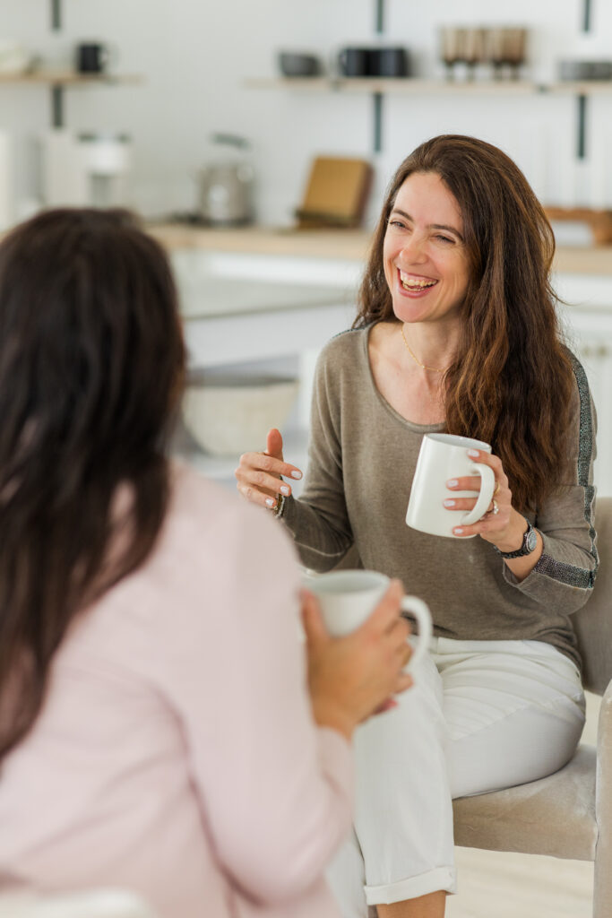 behind the scene of a client meeting both taking and smiling with a kitchen background