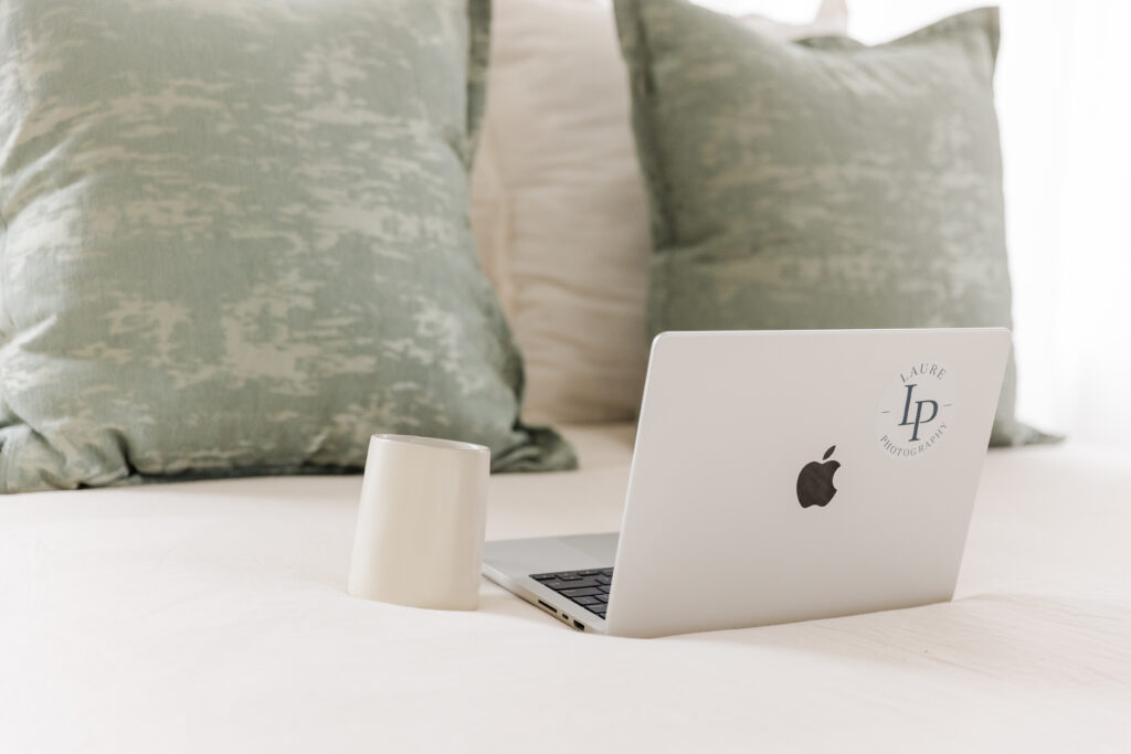 brand photo session detail of a laptop and coffee mug on a bed all colors coordinating