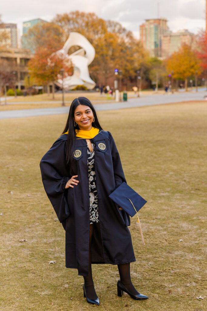 Pallovi standing in the middle of Georgia Tech green space with a white statue in the background