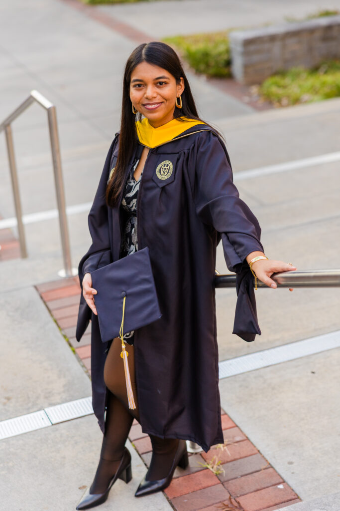 Pallovi leaning against a railing on Georgia Tech stairs during her graduation photo session