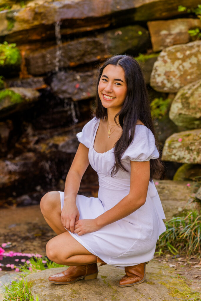 Senior squatting near small waterfall in Atlanta park