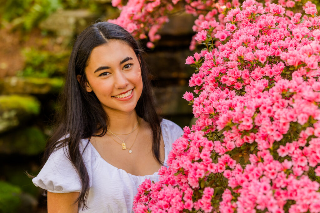 Close-up of Atlanta senior surrounded by pink spring flowers