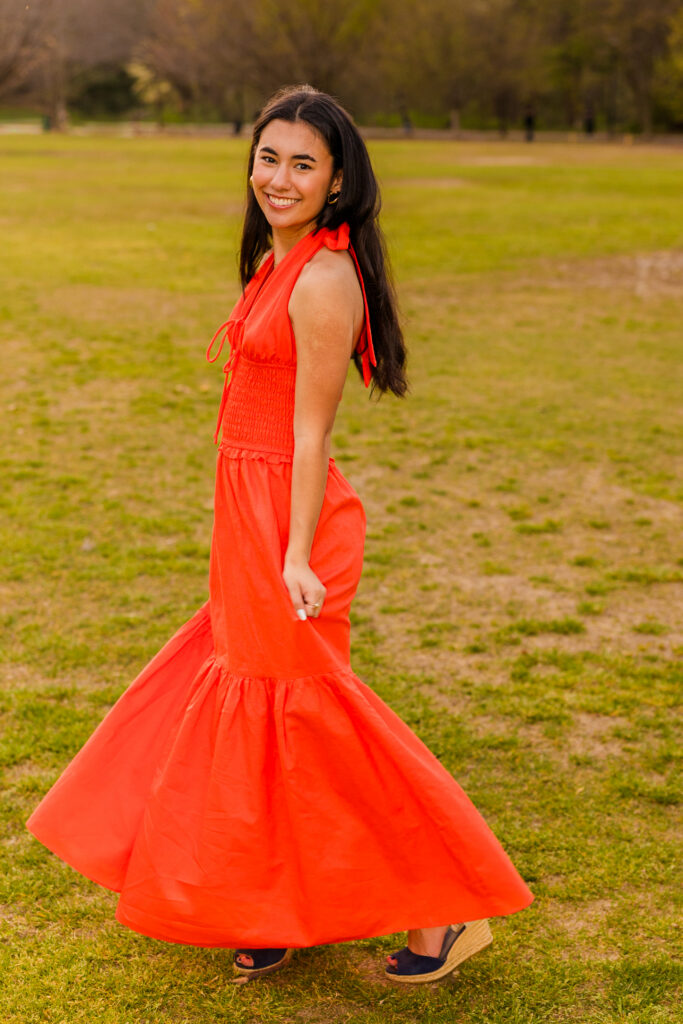 Atlanta senior photos by Laure Photography of senior twirling in orange dress