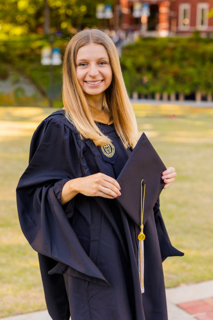 Close-up graduation portrait of Gabriela in cap and gown at Georgia Tech
