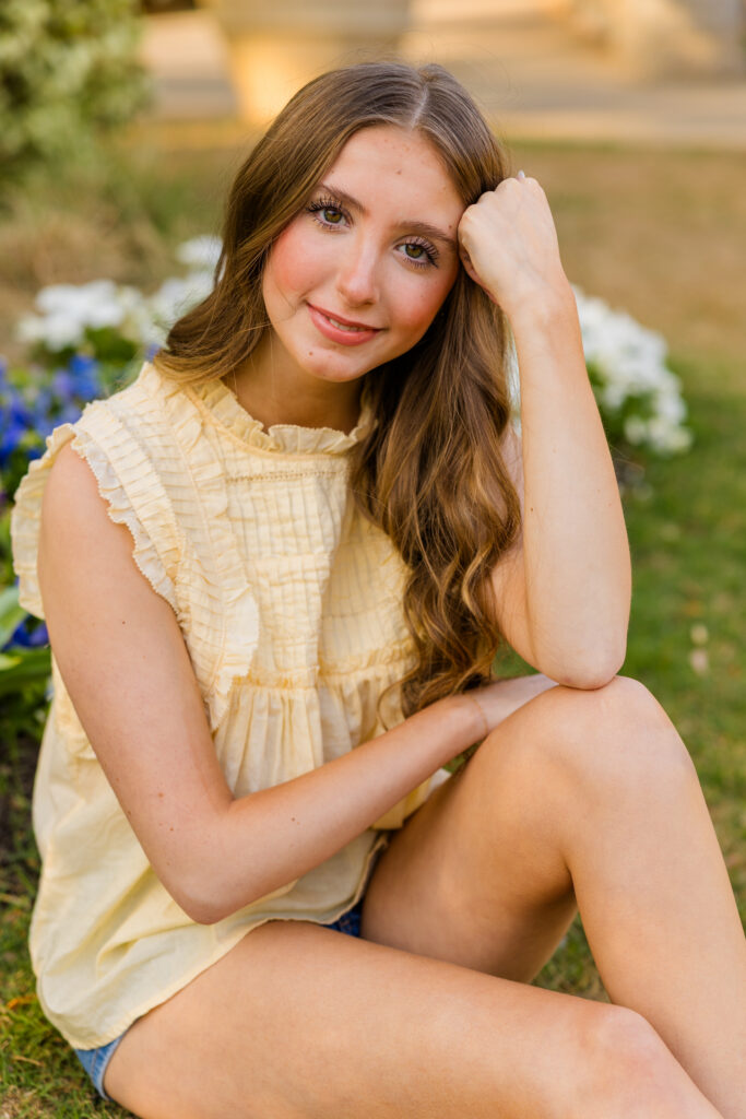 High school senior sitting on grass in Piedmont Park Atlanta during golden hour