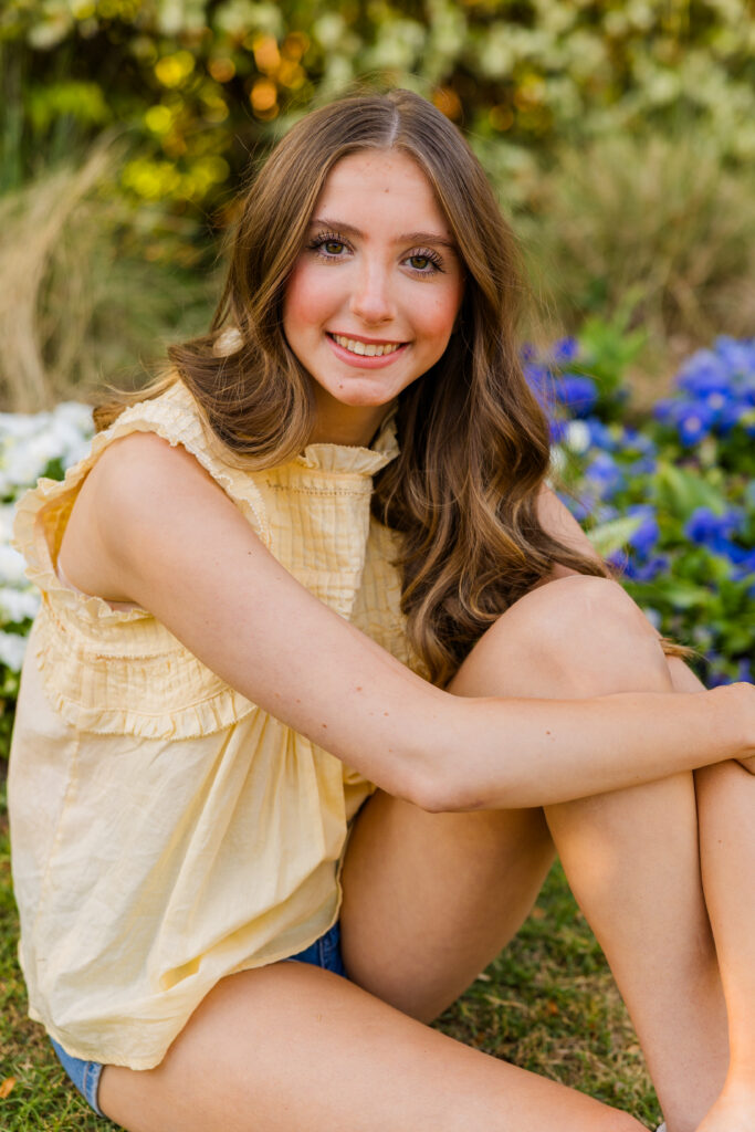 Senior girl sitting in front of flowers in Piedmont Park Atlanta