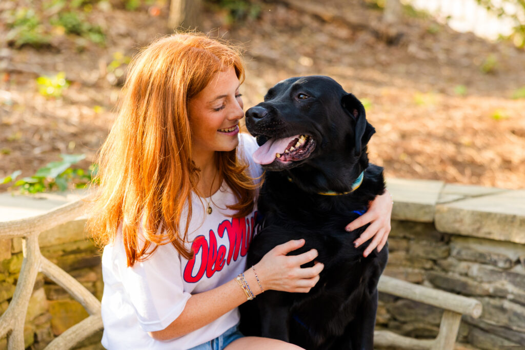 Senior girl hugging her dog during outdoor senior photos in Sandy Springs Atlanta