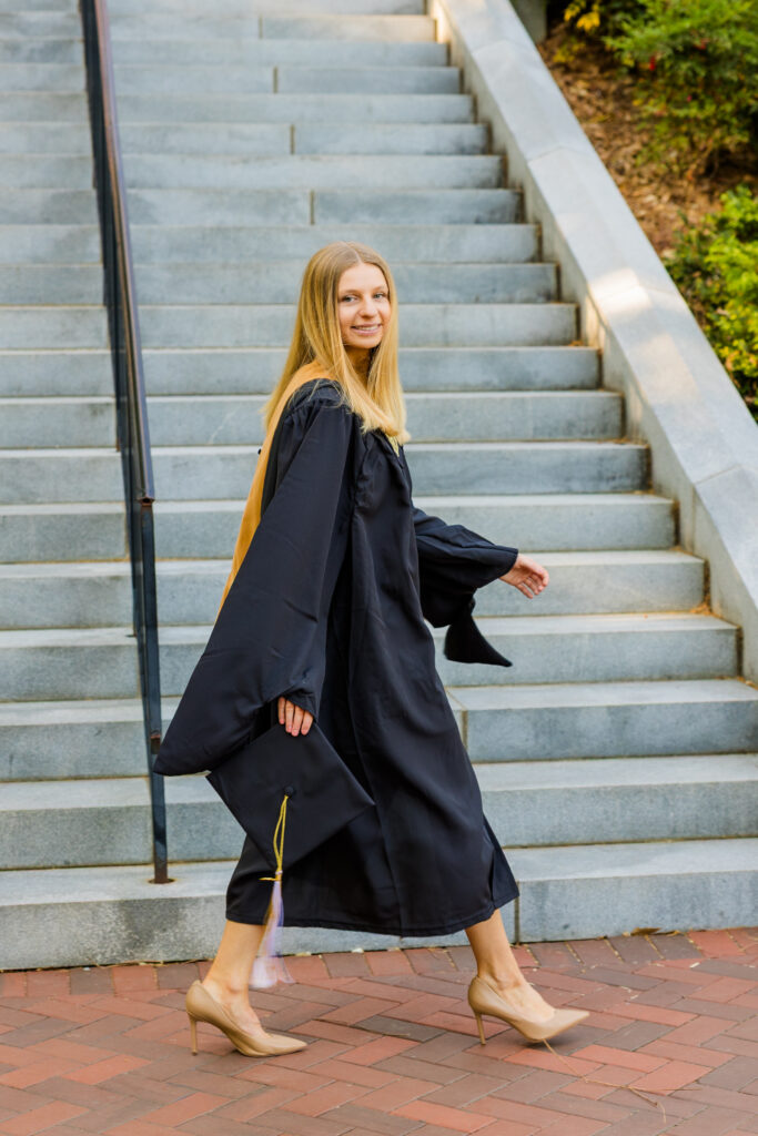 Gabriela looking back while walking in front of the Georgia Tech Tower stairs